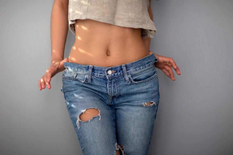 Young woman in crop top showing stomach and ab muscles