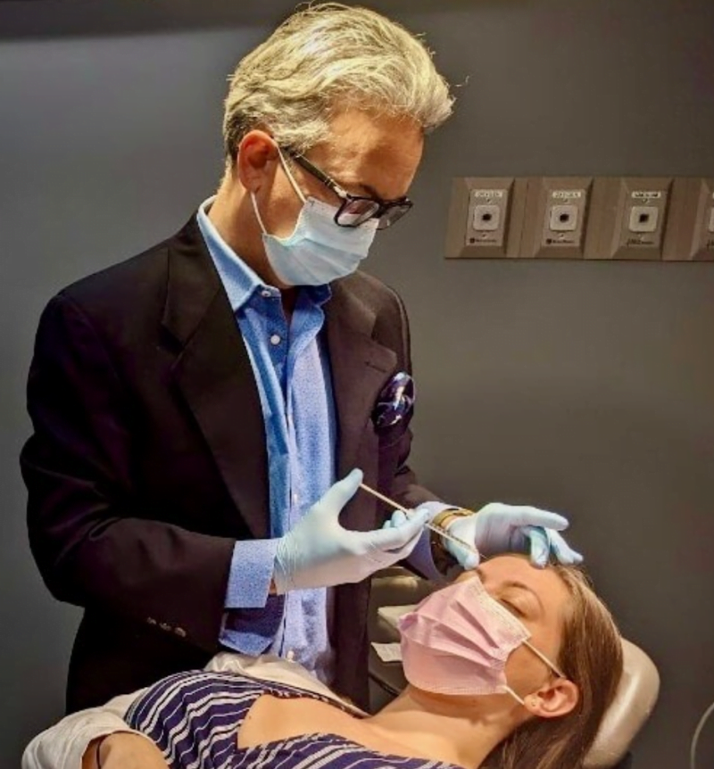 Dr. Henry Garazo administering Botox injections on a patient