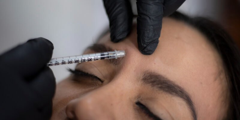 Close up of woman getting forehead wrinkle treatment injections